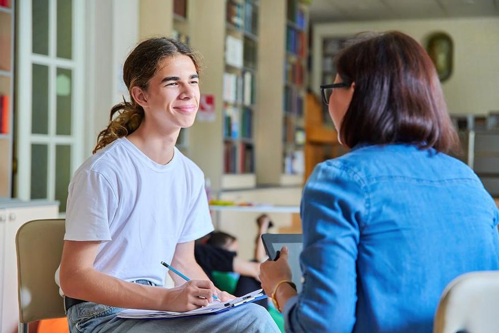 Teacher helps a student