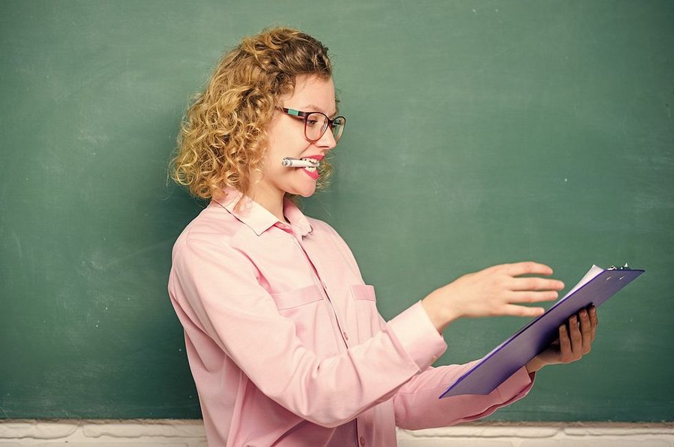 Teacher looks at her lesson plan during an observation