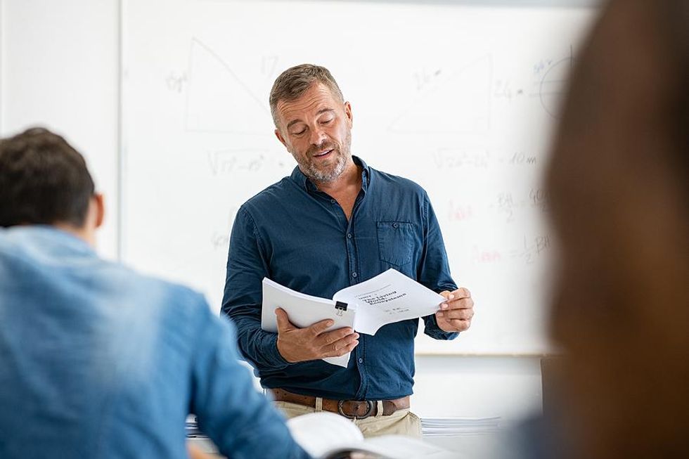 Teacher reads an assignment to the class