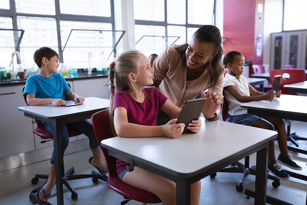 Teacher smiles at her student