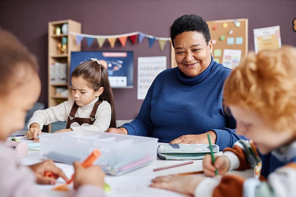 Teacher smiles at her students