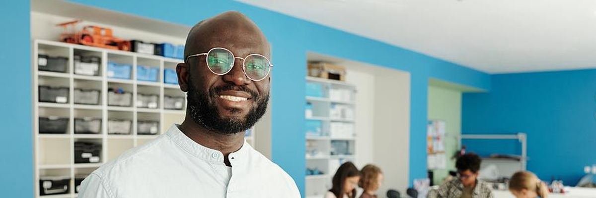 Teacher stands in his classroom