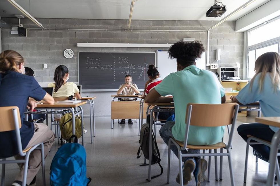 Teacher talks to his students