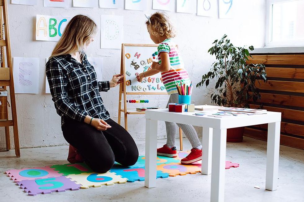 Teacher teaches a young student vocabulary