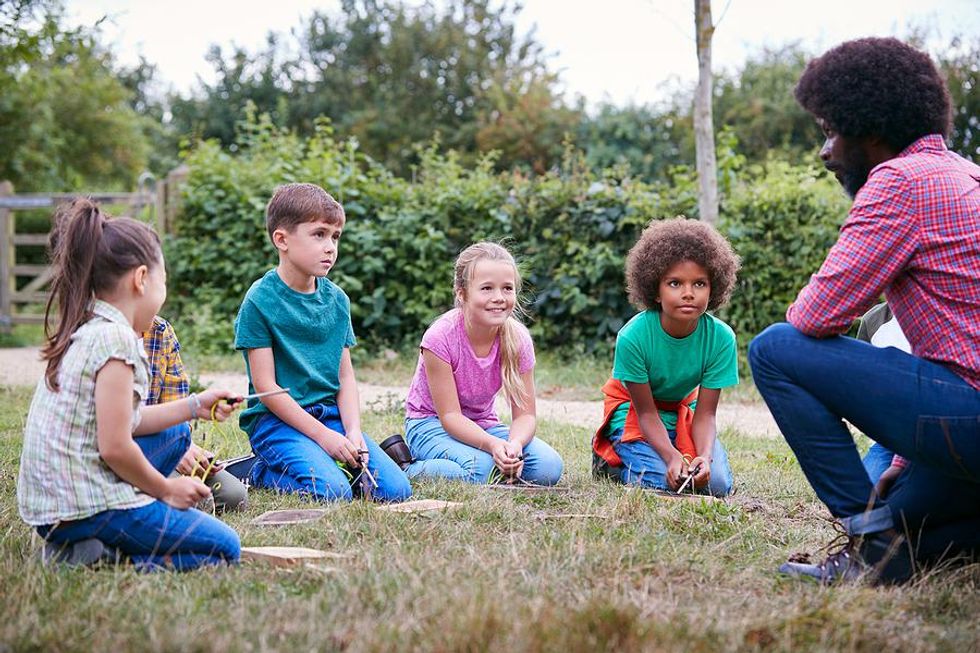 Teacher teaches his class outside