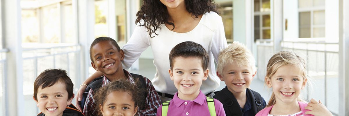 Teacher works with students during the summer