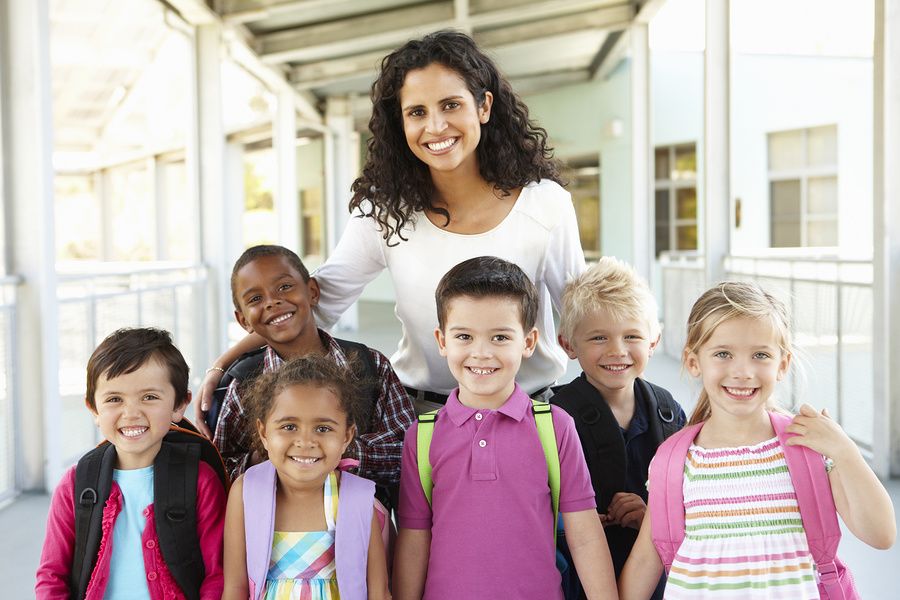 Teacher works with students during the summer