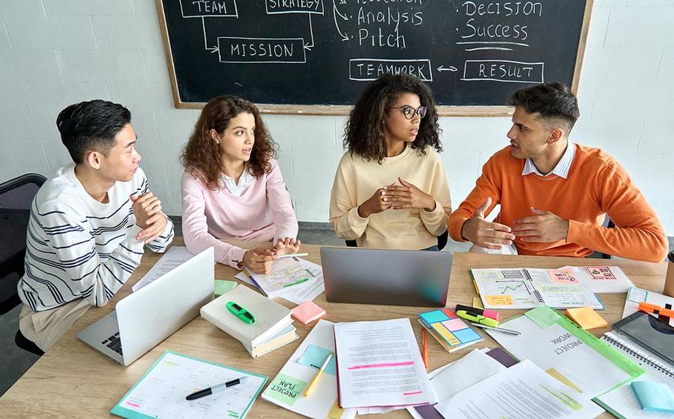 Team members work on a project together during a meeting