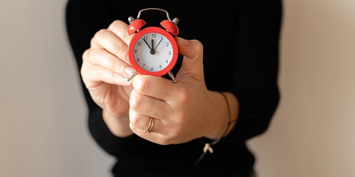 time management concept woman holding clock