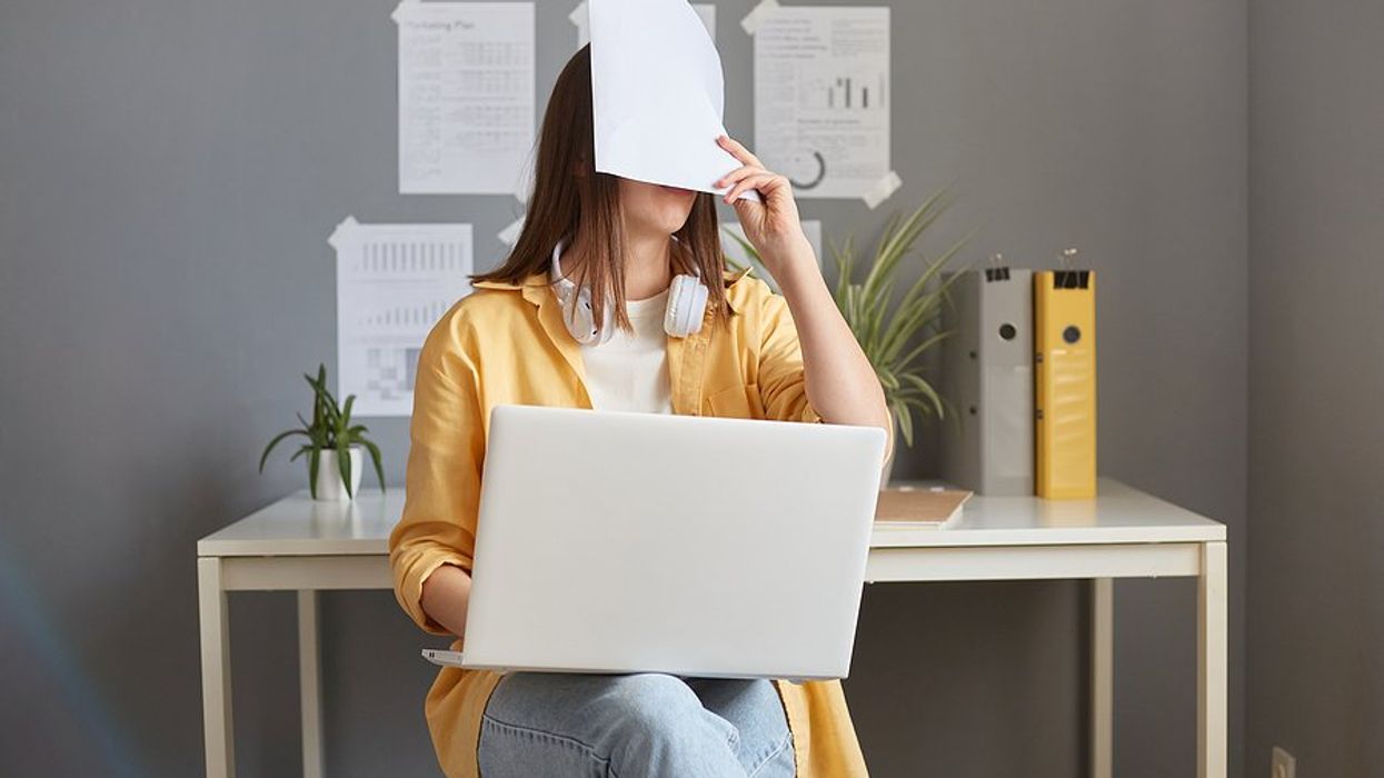 Tired/exhausted/frustrated woman on laptop makes cover letter mistakes