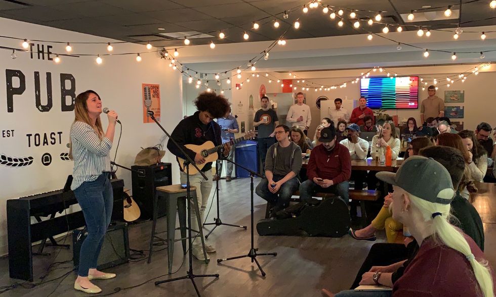 Toast employees enjoy some music in the Toast Pub.