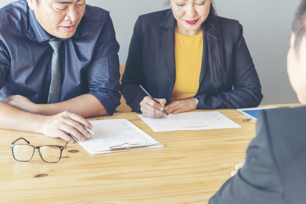 Two business professionals review a candidate's resume.