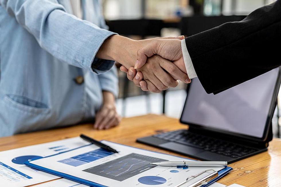 Two businesspeople shake hands after a meeting