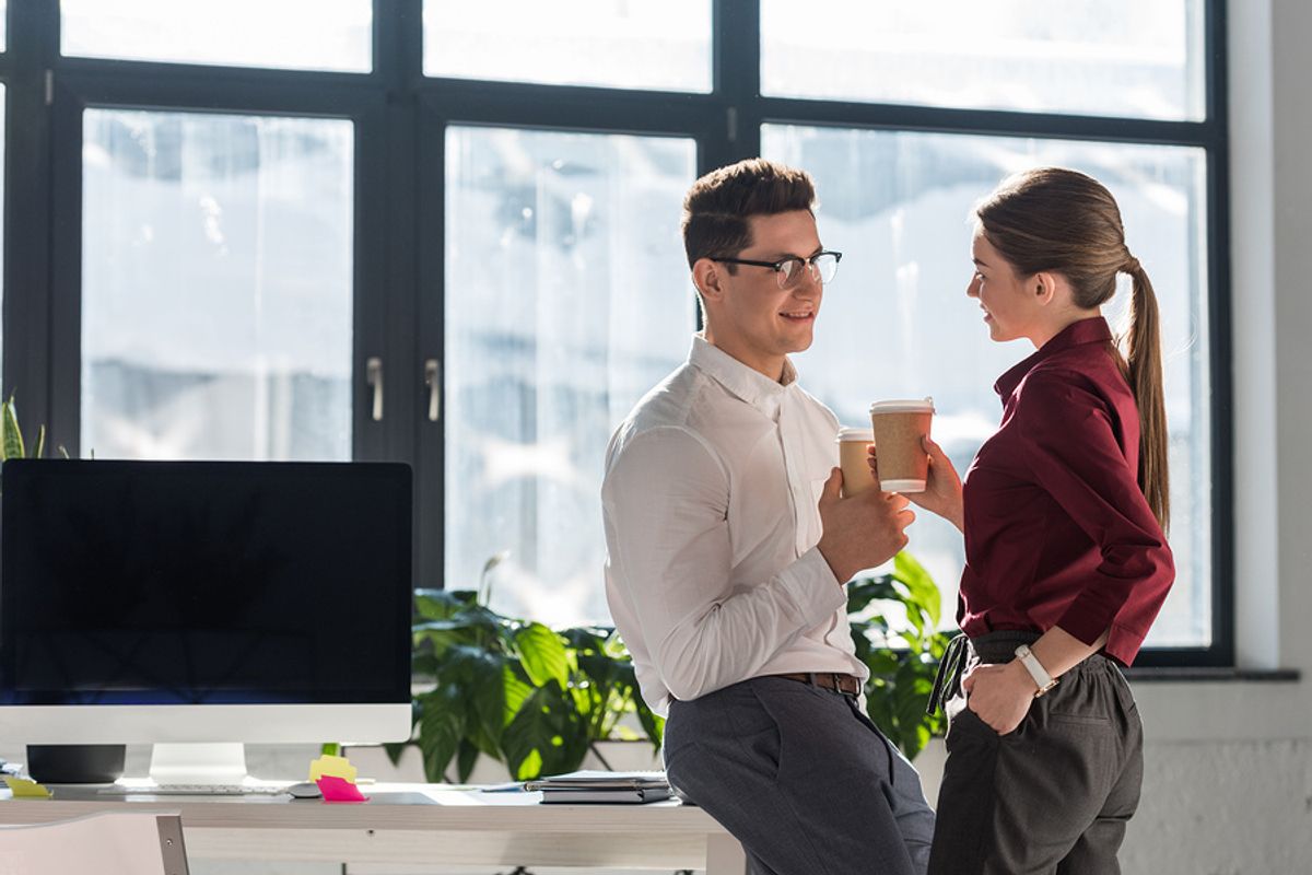 Two co-workers flirt in the office