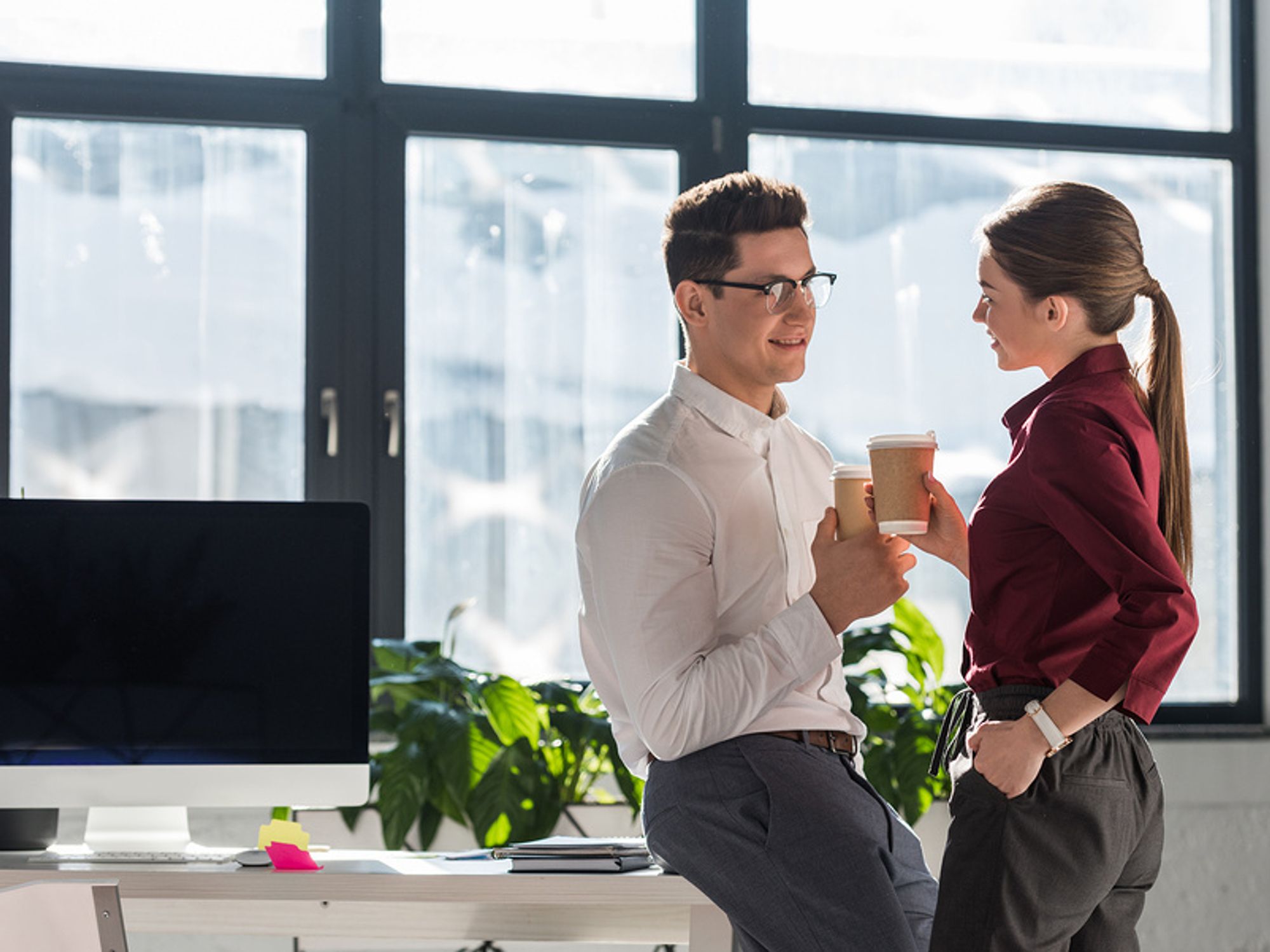 Two co-workers flirt in the office