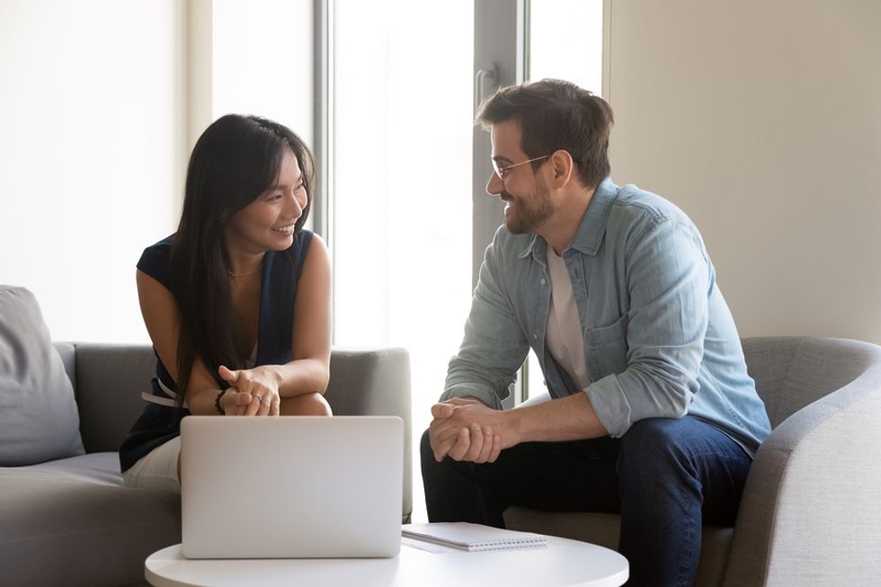 Two co-workers flirt while working on a project