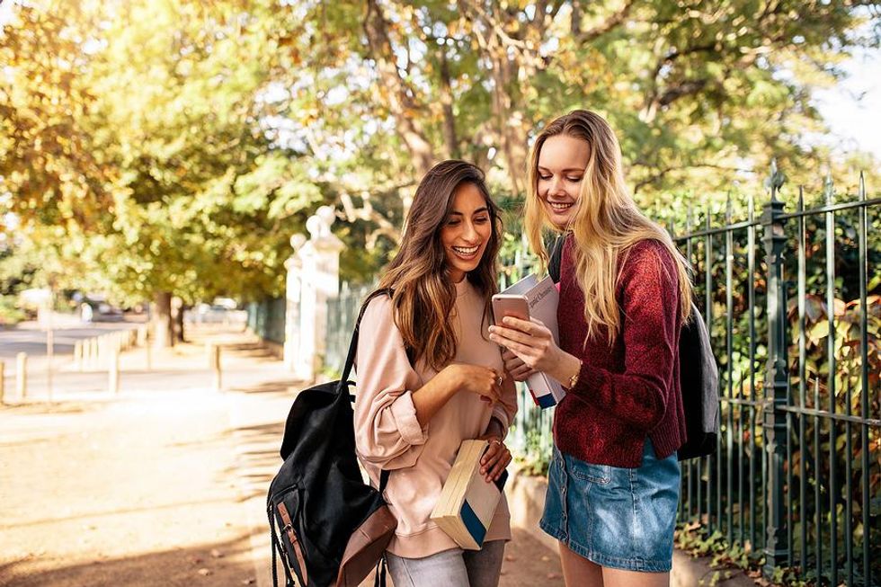 Two college students watch TikToks