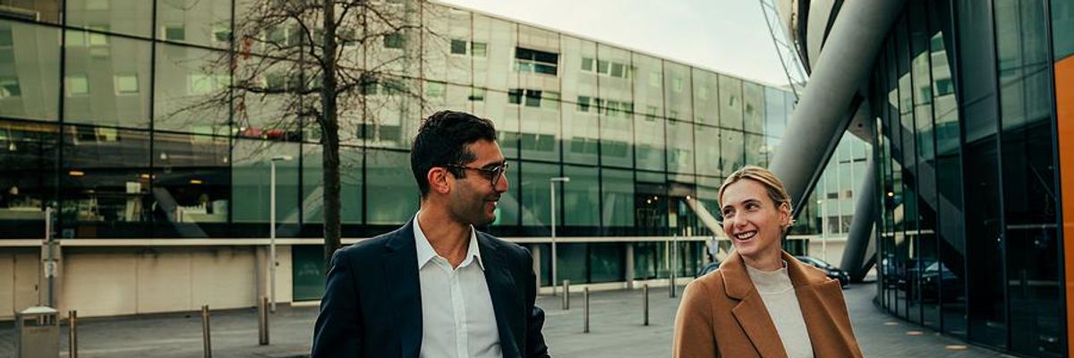 Two coworkers go for a walk at work