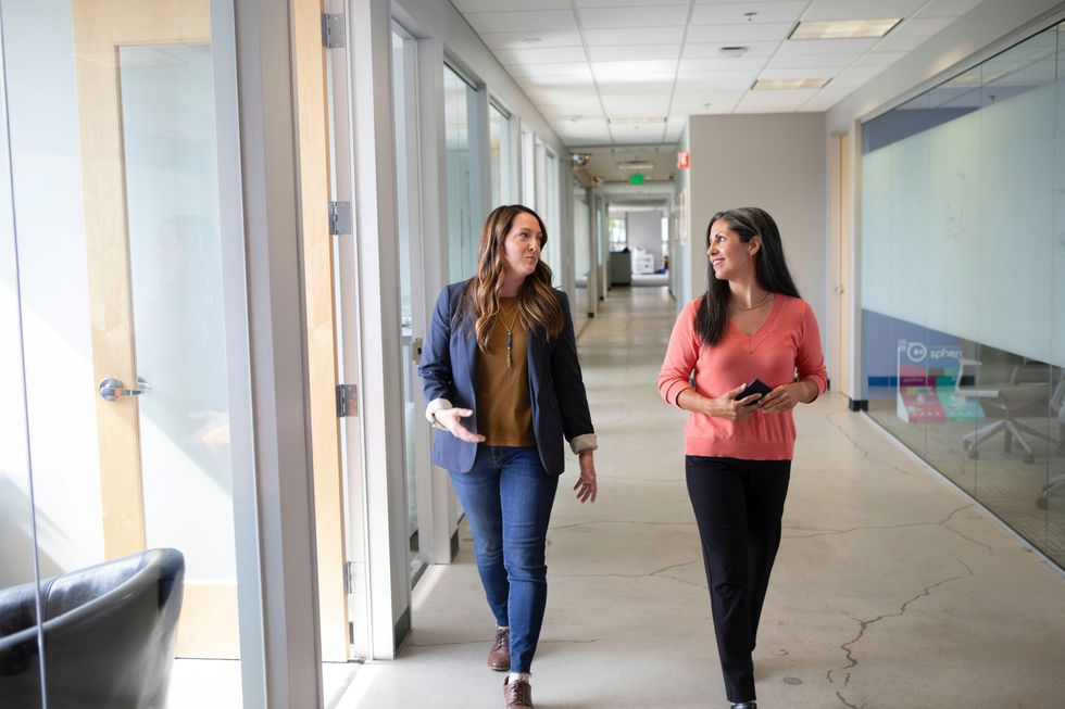 Two coworkers talk in the office