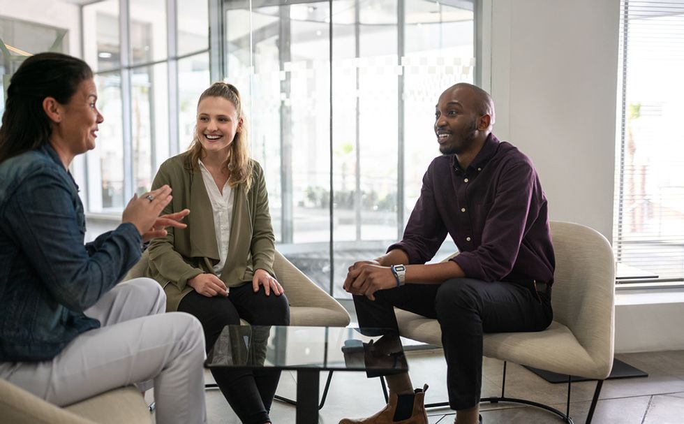 Two employees build a relationship with their boss during a work meeting and manage up