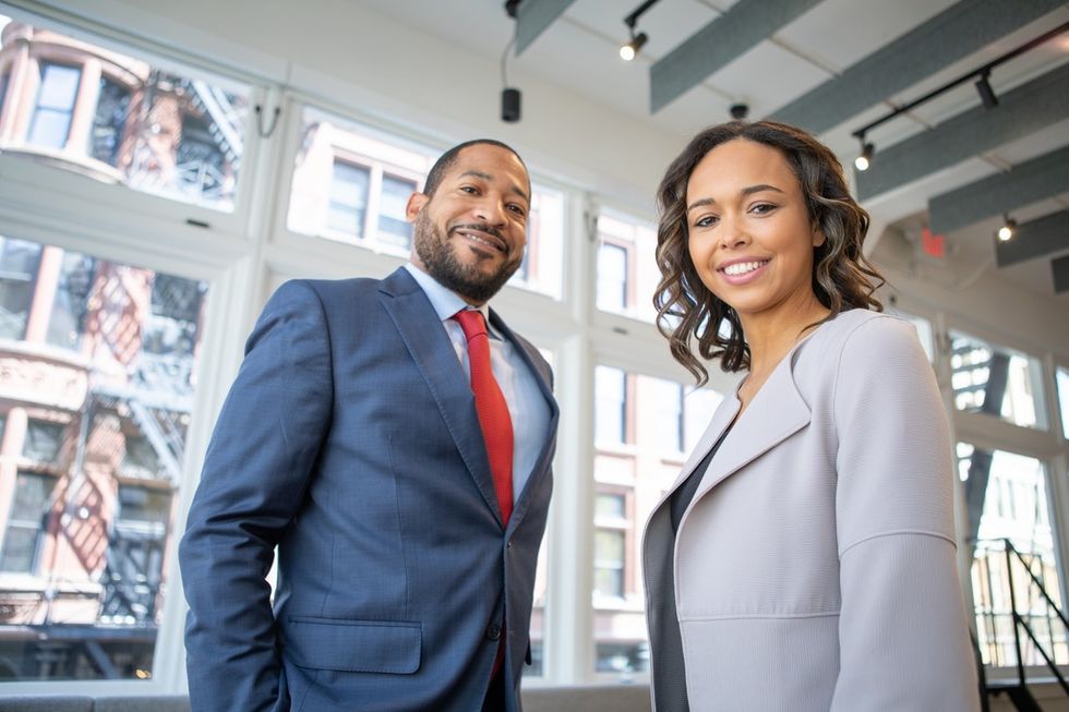 Two employees smiling about their jobs