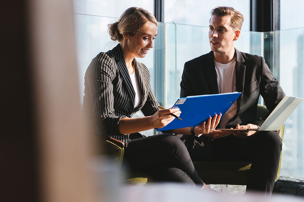 Two executives look at data during a meeting