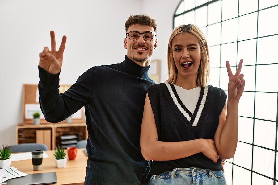 Two happy employees having fun at work