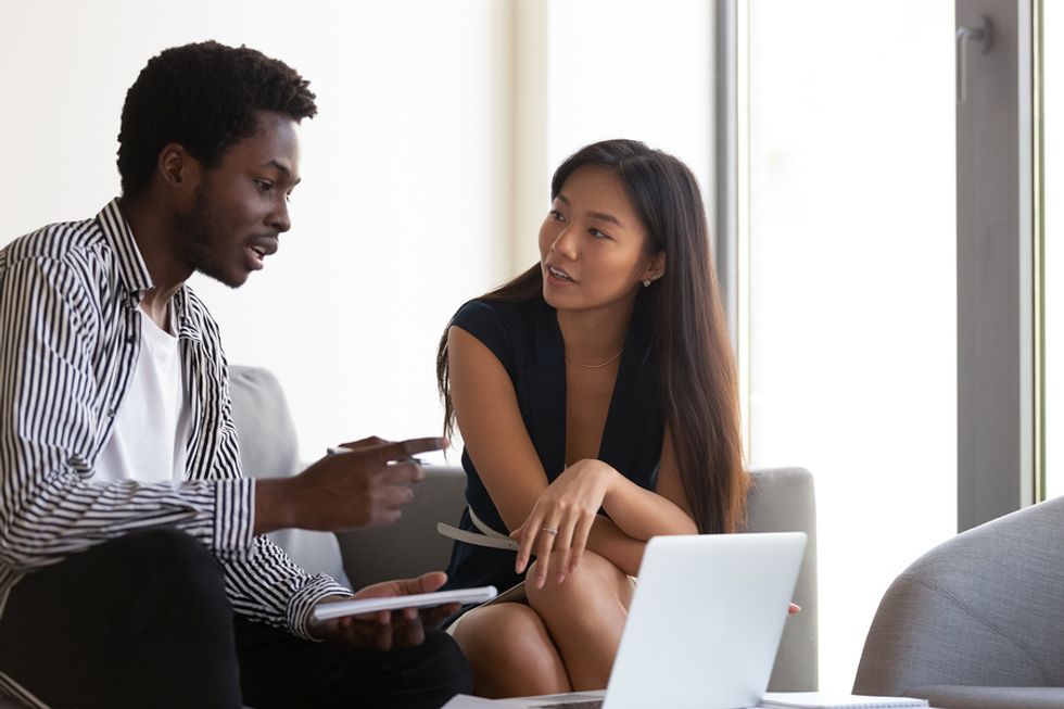 Two interns talk during a meeting