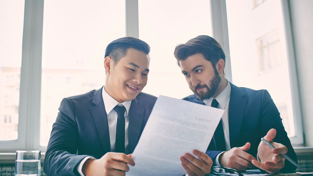 Two men looking at resume explaining a job gap