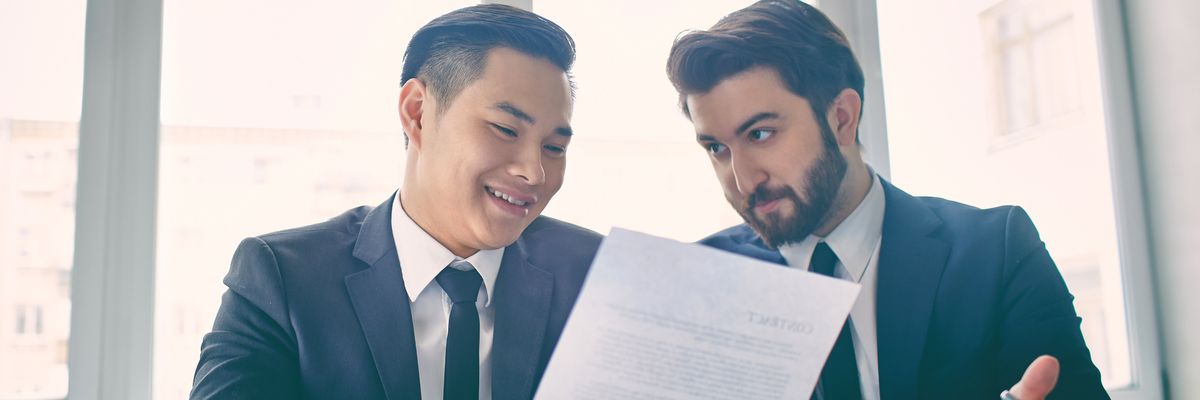 Two men looking at resume explaining job gap