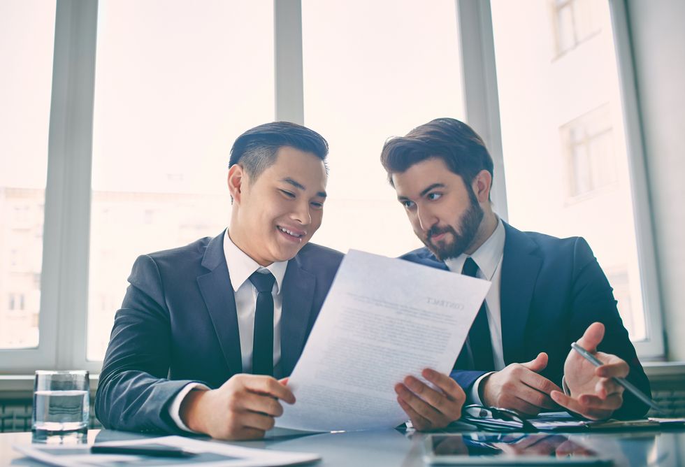 Two men looking at resume explaining job gap