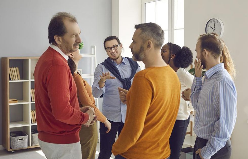 Two men talk at a networking event