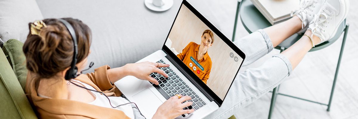 Two professionals chat during an online networking meet-up.