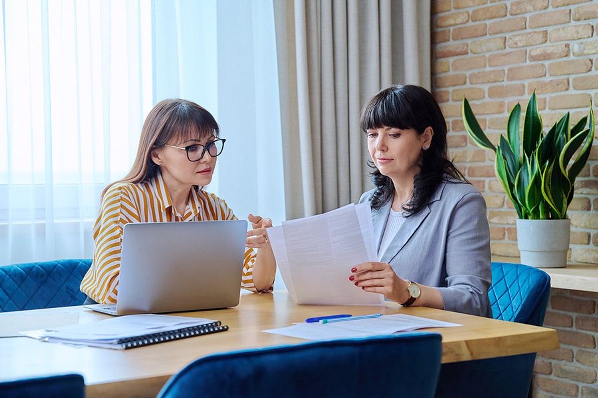 Two recruiters/hiring managers review candidates' resumes