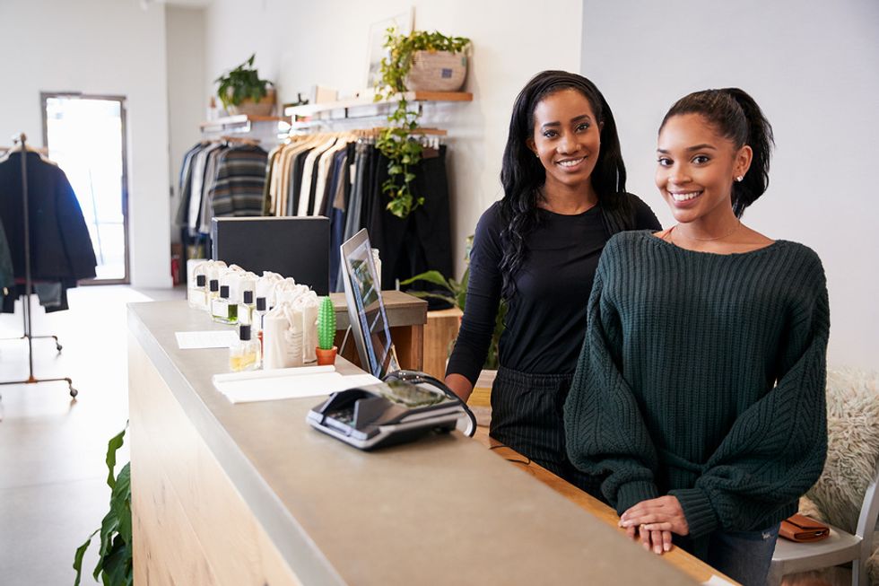 Two retail managers working at a clothing store