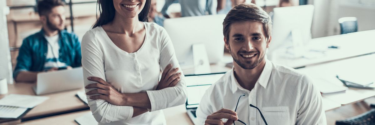 Two smiling employees with good soft skills