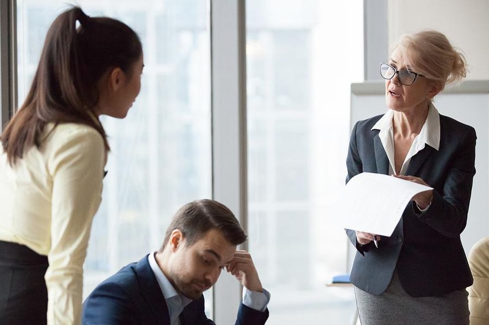 Upset boss talks to employees