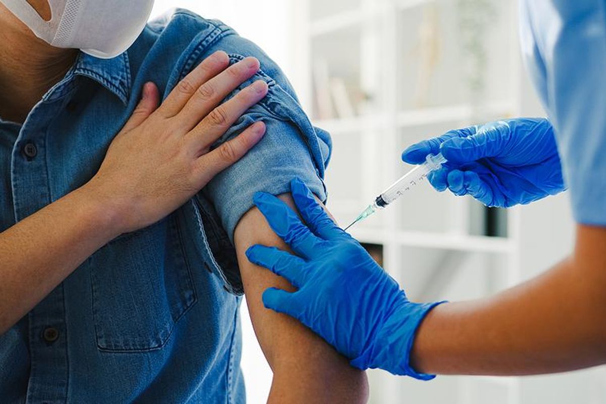 Vaccine specialist immunizes a patient