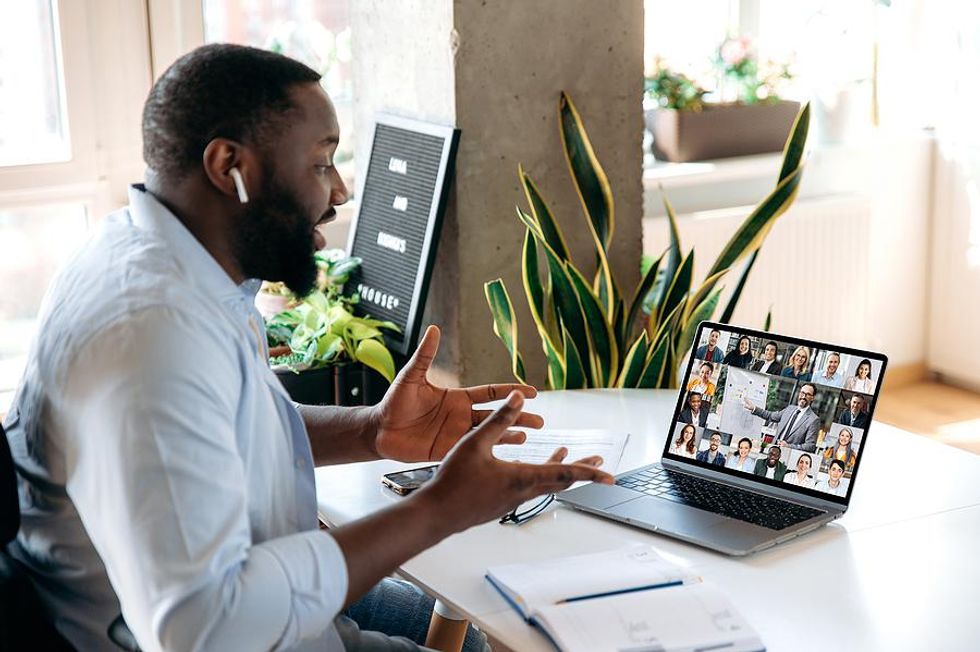 Virtual leader talks to his employees during a work meeting