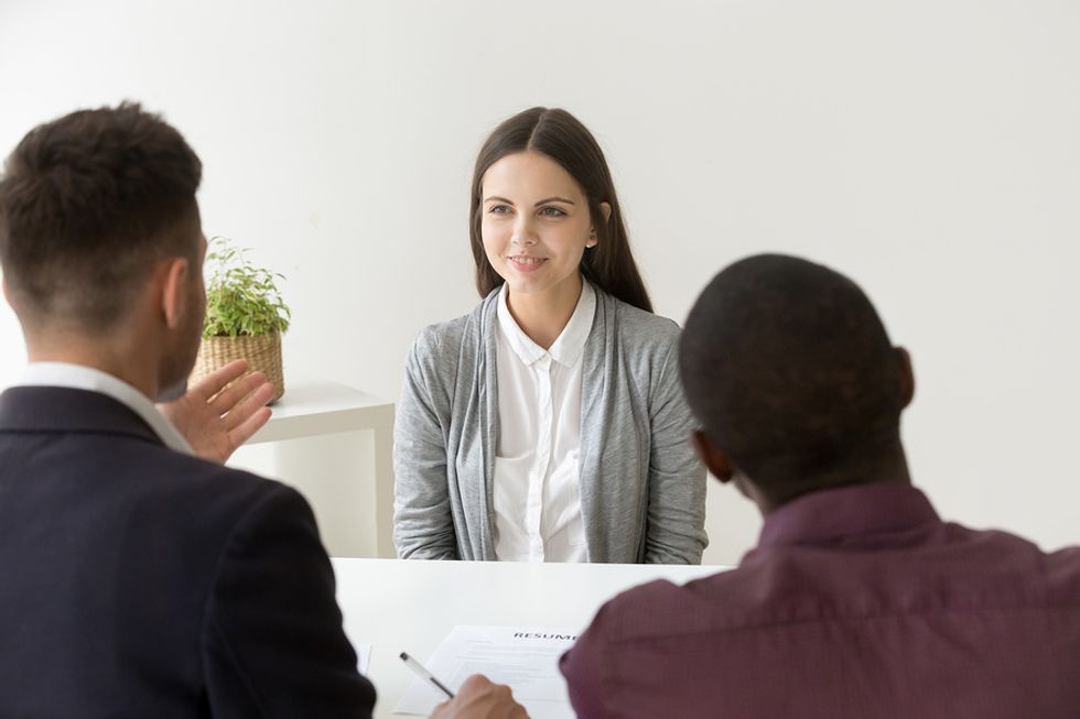 The woman answers the interview question. "Why are you interested in this position?"