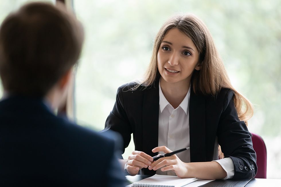 Woman answers the question, "Tell me about yourself," in a job interview.