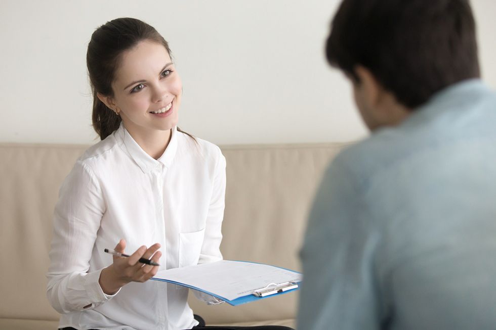 Woman asks a job candidate an interview question