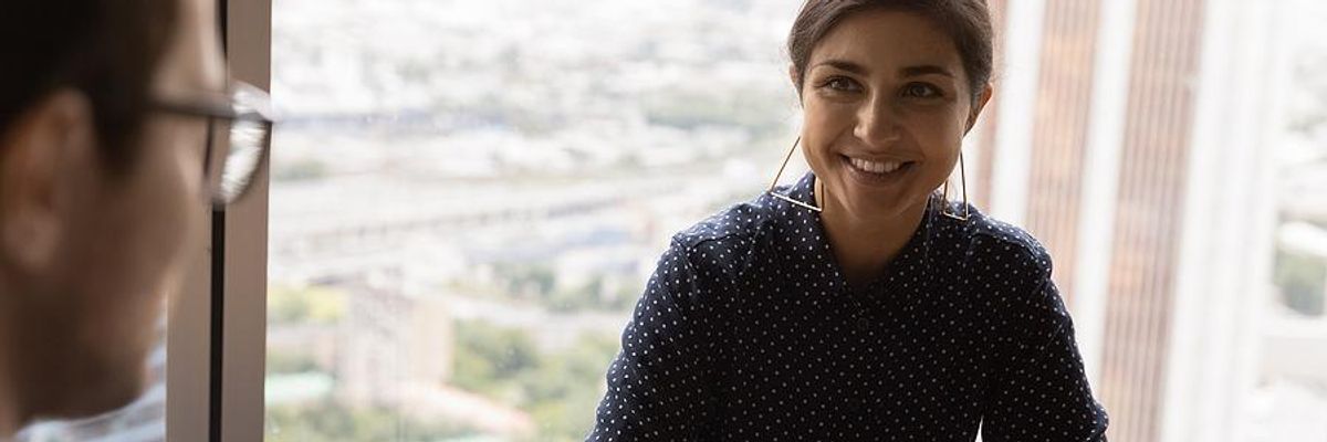 Woman asks the hiring manager a question during her job interview