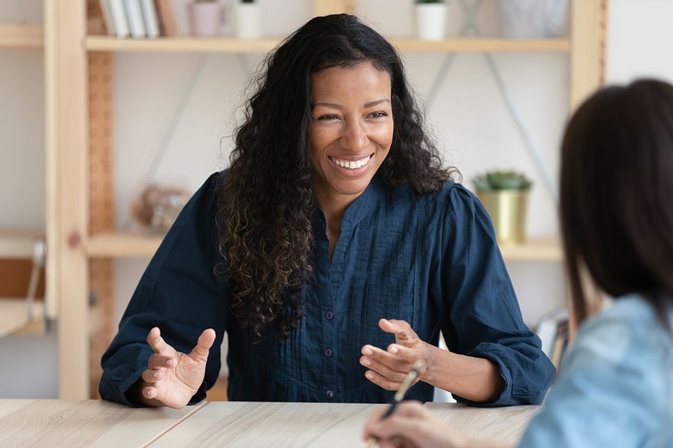 Woman asks the hiring manager questions during her job interview