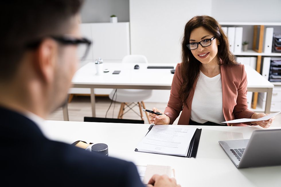 Woman conducts a mock interview with a work colleague