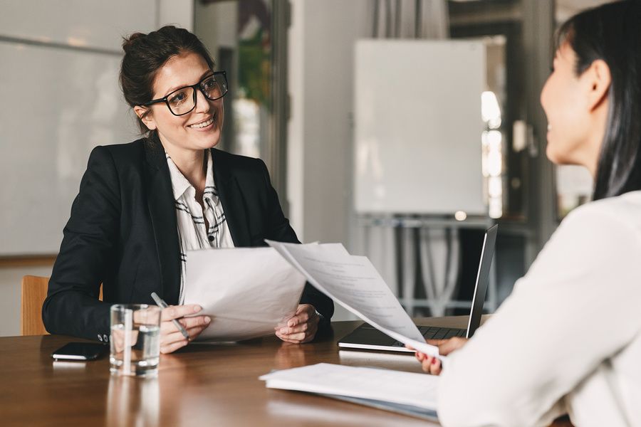 Woman conducts a mock interview with her colleague