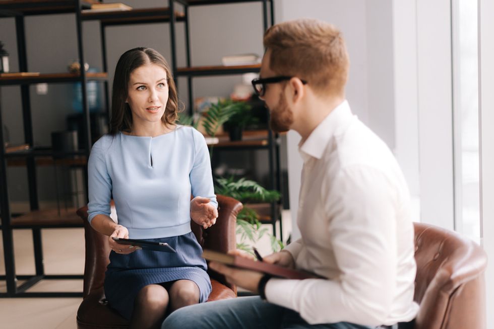 Woman confiding in a friend about her work crush