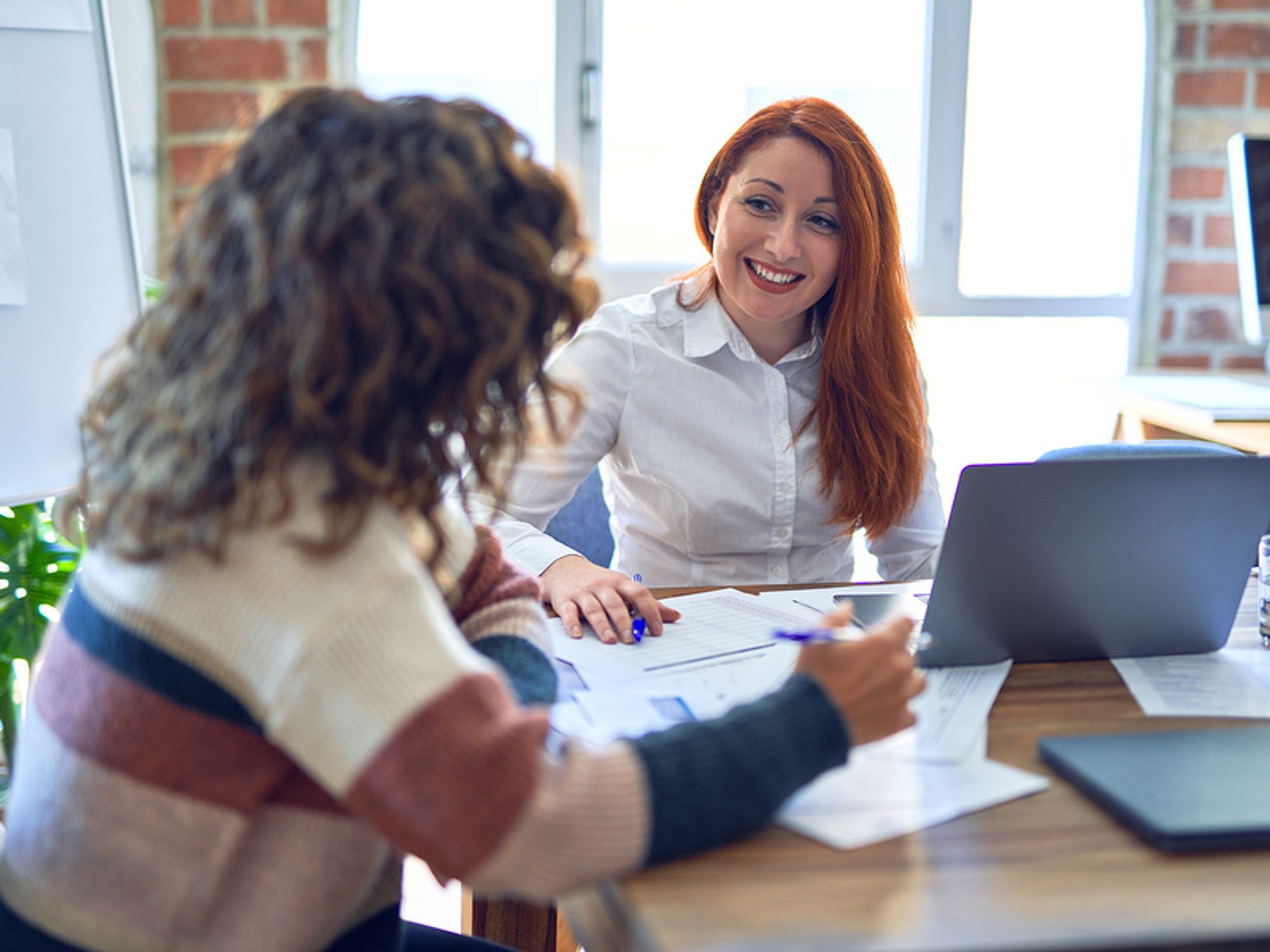 Woman connects with her new boss during a work meeting