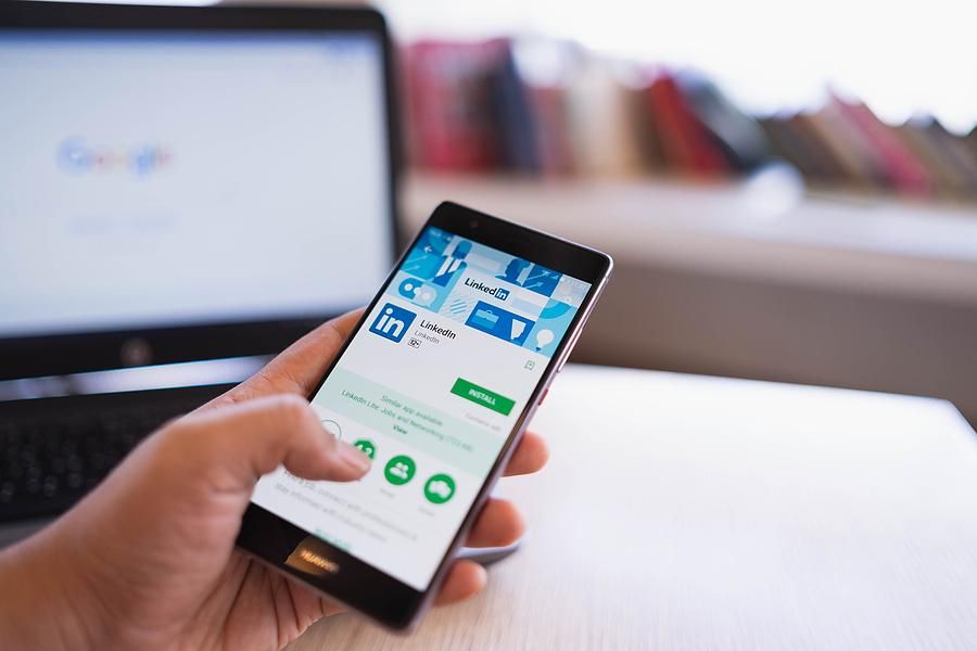 Woman downloads LinkedIn app on her phone