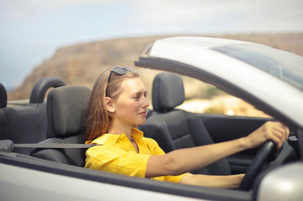 Woman driving thinking about her new job offer
